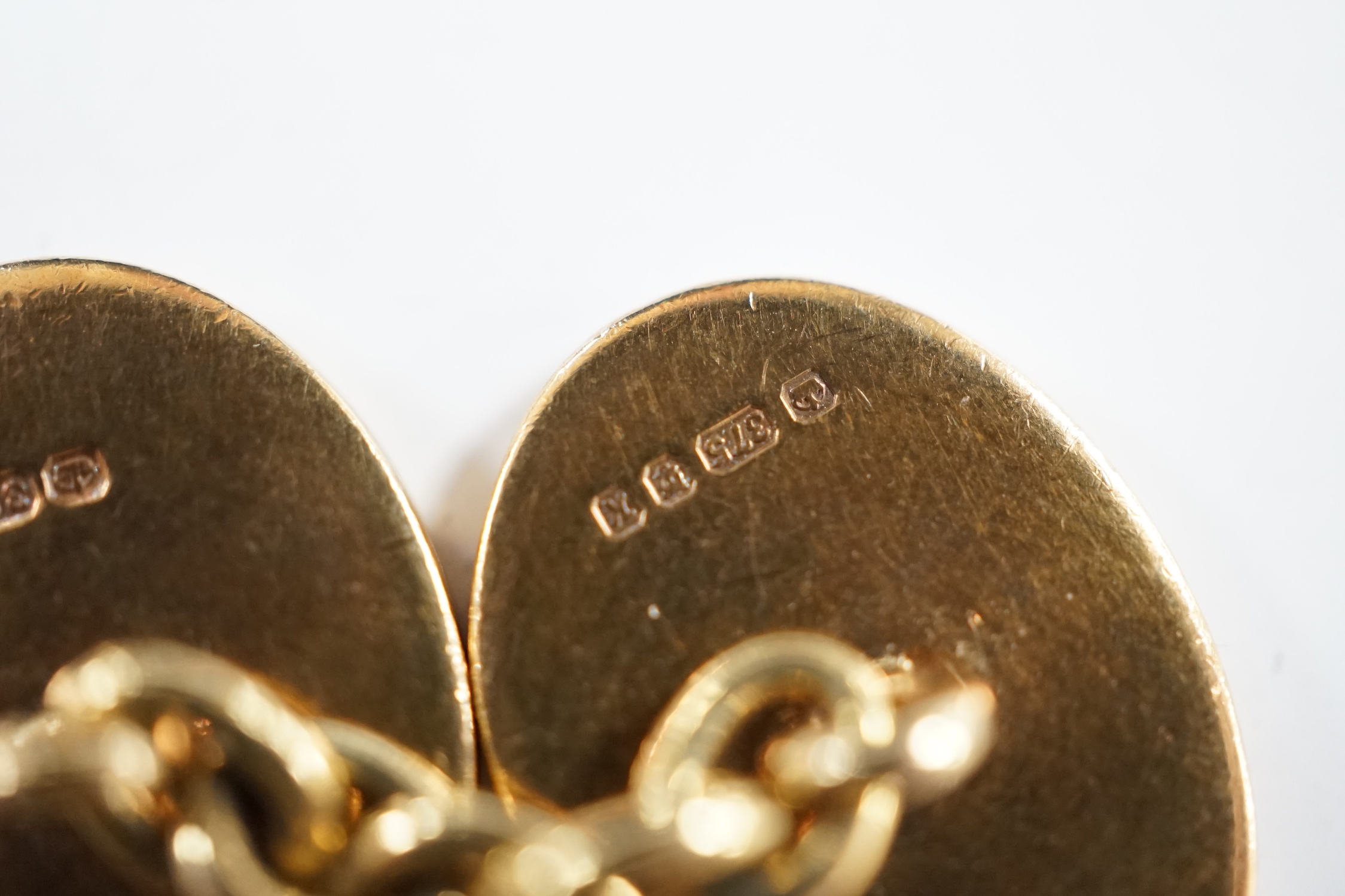 A pair of early 1960's 9ct gold oval cufflinks, with engraved crest and monogram, 10.3 grams.